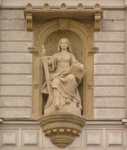 Photo of statue 'Lady Justice with sword' placed in a niche in a wall. Photo is made by Michal Maňas