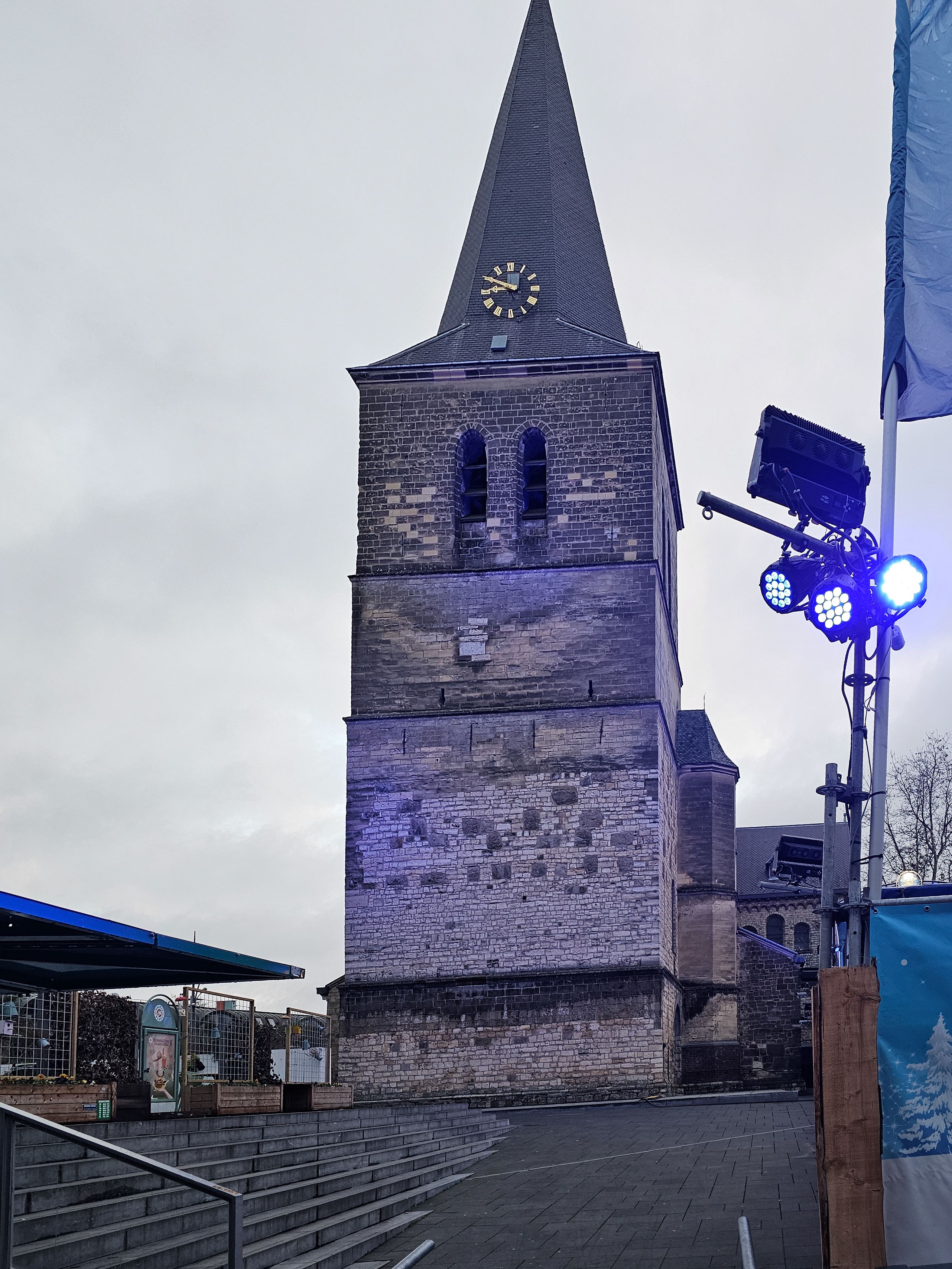Photo showing blue Lights illuminating Church Tower and Square after New Year in Heerlen