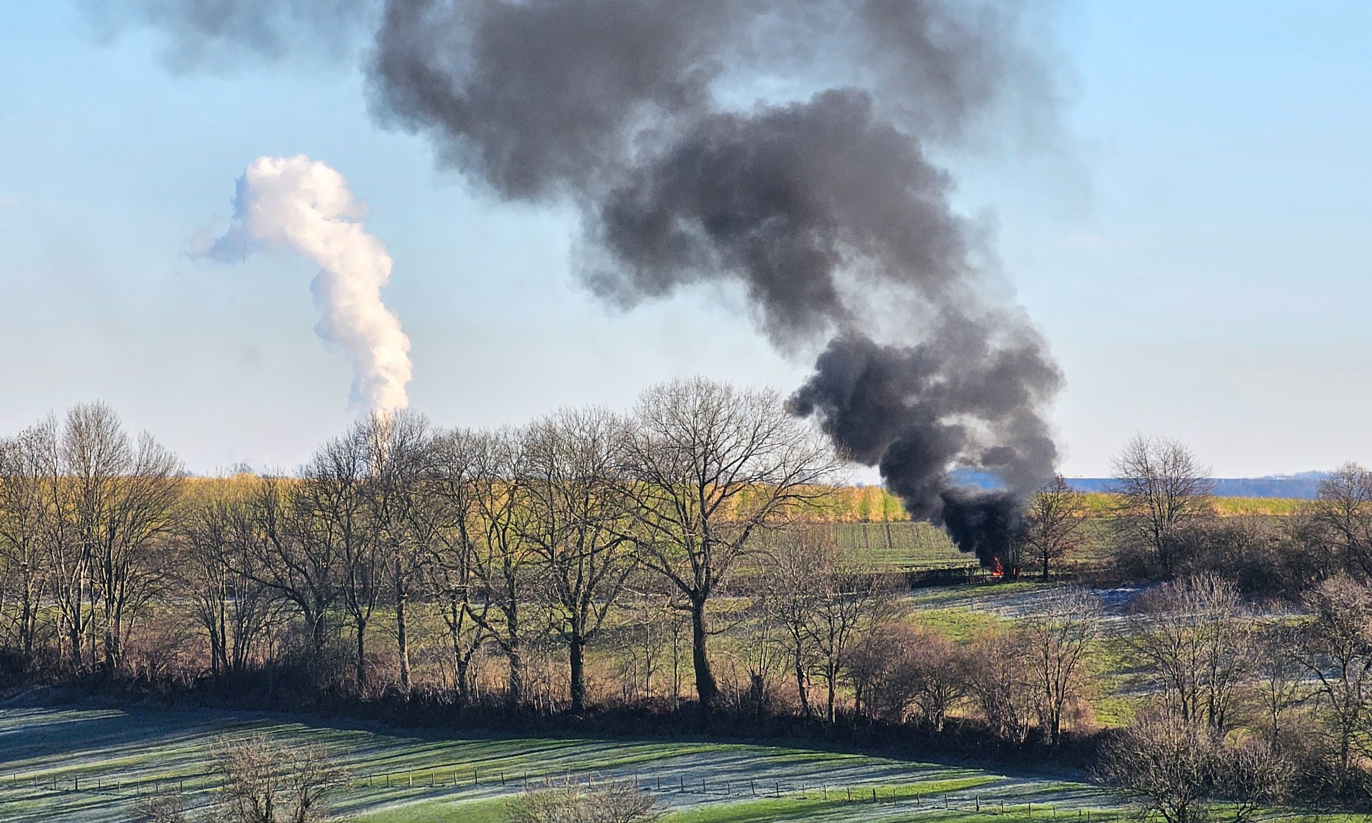 Two Kinds of Smoke rise from this Landscape to Heaven