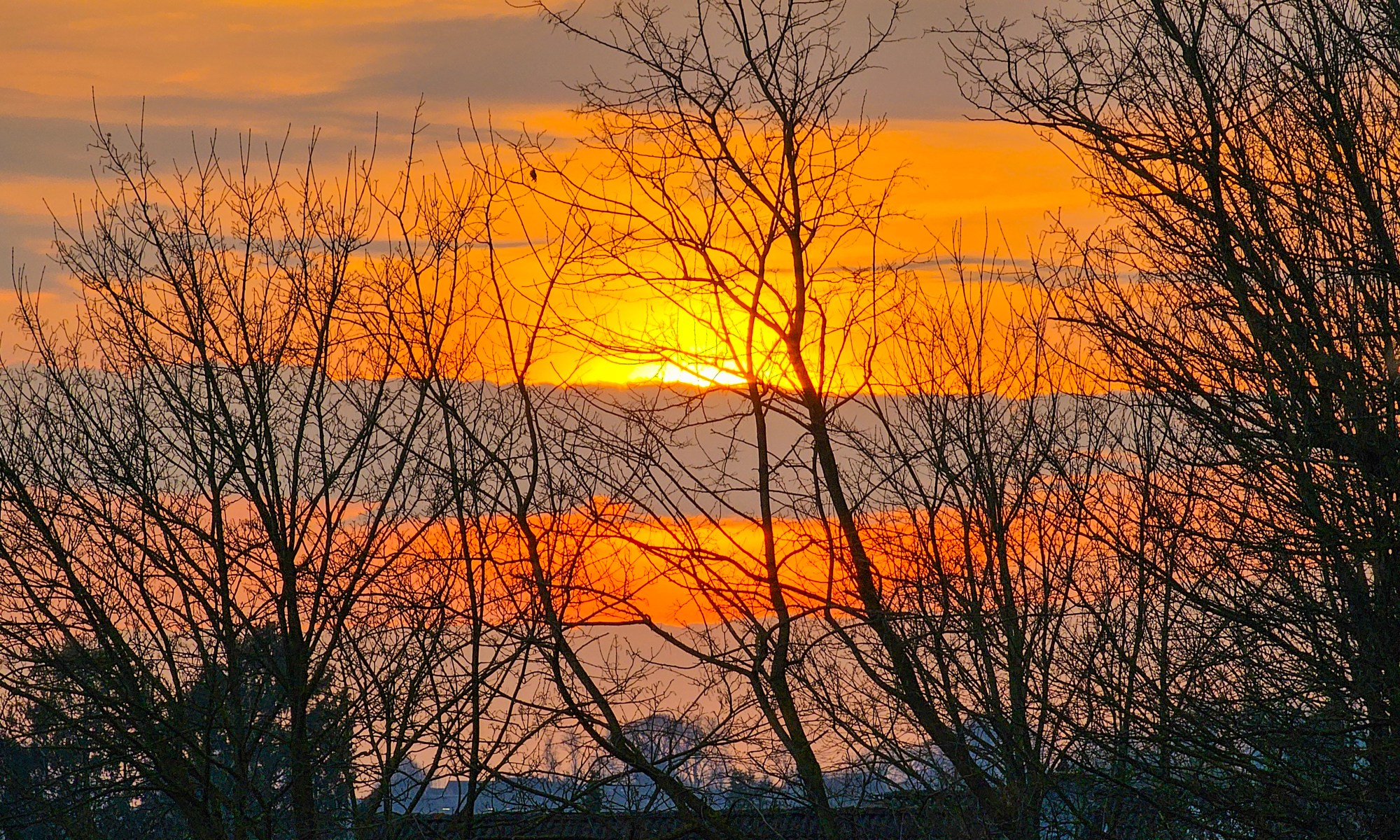 Sun setting behind a Cloud at the beginning of Spring