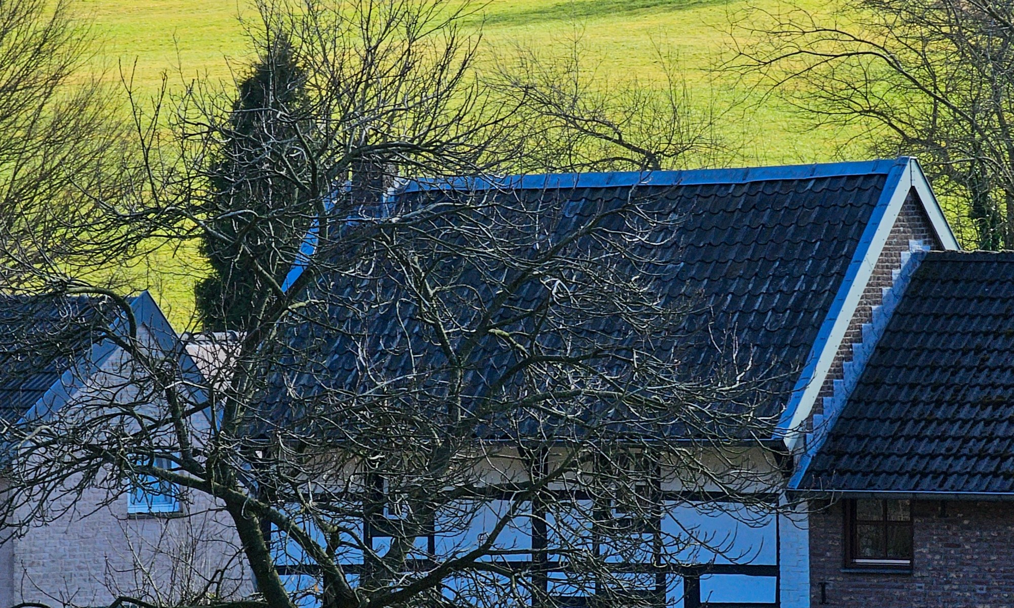 Two half-timbered Houses; one House located in the Valley, the second House placed on Top of the Hill above the first House